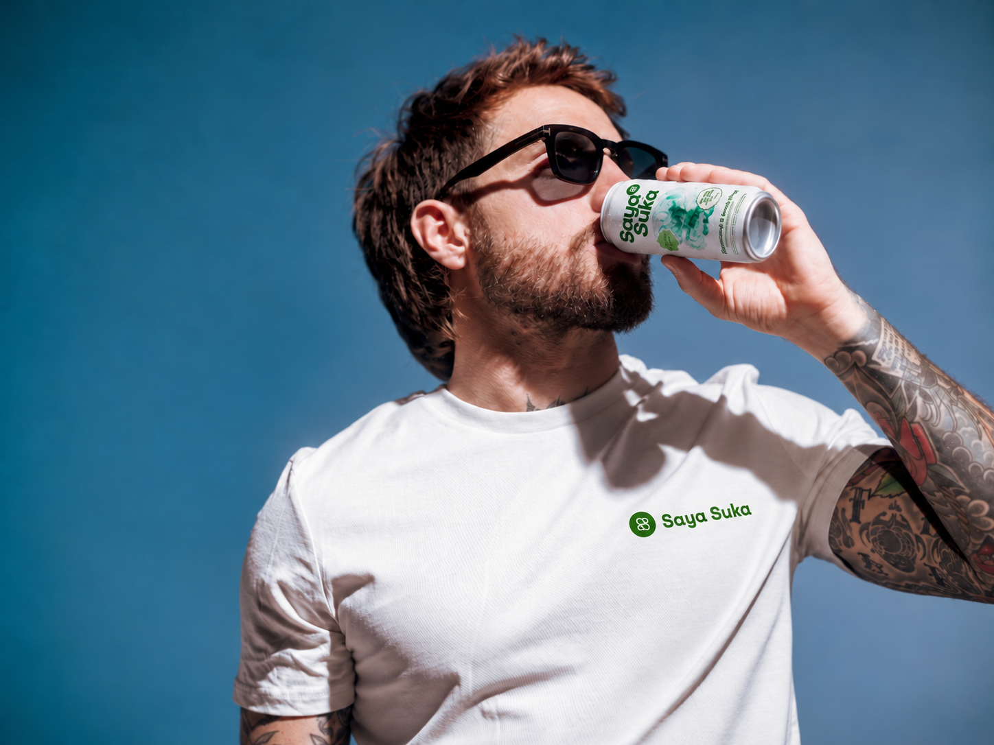 Man drinking Saya Suka Bergamot & Swiss Pine functional sparkling water